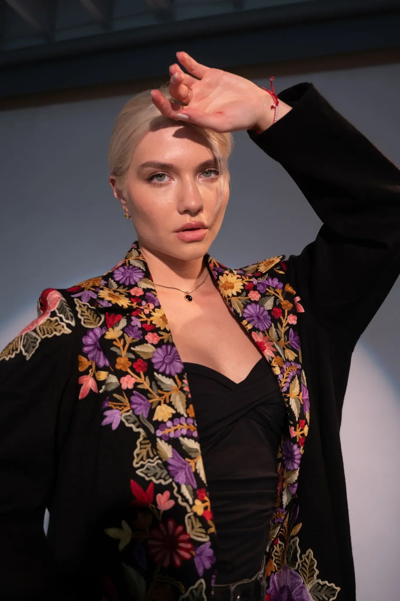 Women posing in black trench coat
