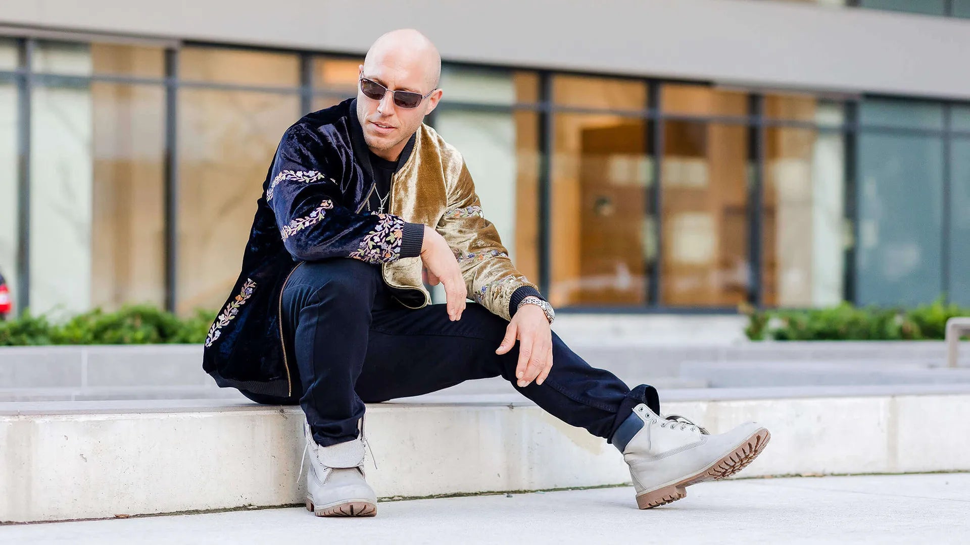 Man styling an ombre jacket outside a building