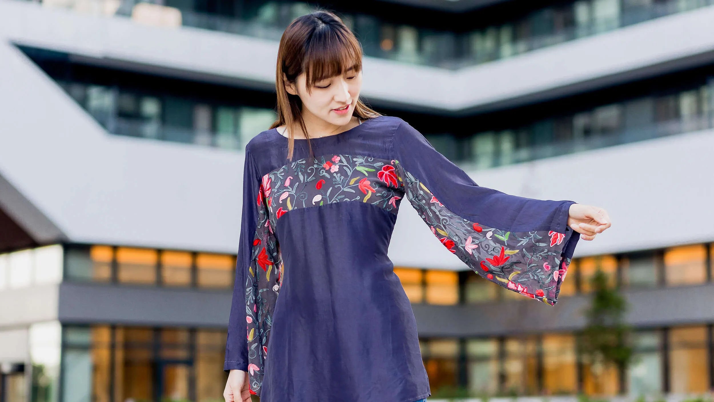 Girl styling an embroidered t-shirt in a posh area