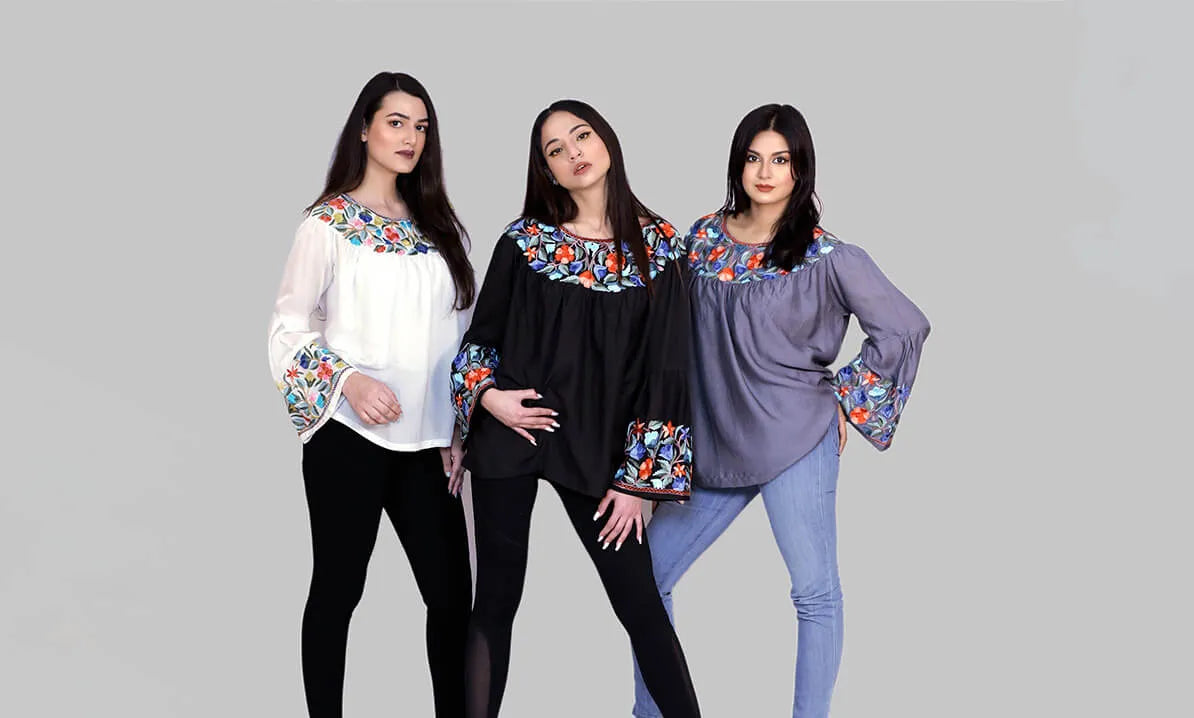 3 women standing together styling tops